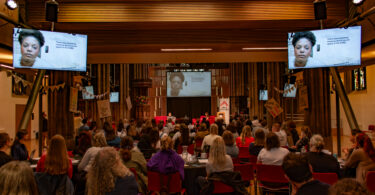 Event in P&G church, Edinburgh. Around 100 people at the event, looking towards the stage with screens.
